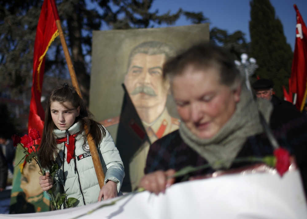 2016年12月21日，在前蘇聯獨裁領導人史達林（Josef Stalin）的家鄉喬治亞（Georgia），民眾手持旗幟慶祝他的冥誕。（湯森路透）