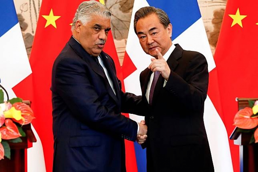 中國外交部長王毅（右）與多明尼加外交部長巴爾加斯（左）1日於北京簽署建交公報。（湯森路透）