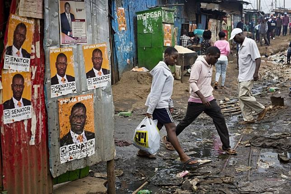 肯亞首都奈洛比的貧民窟張貼著選舉海報。（美聯社）