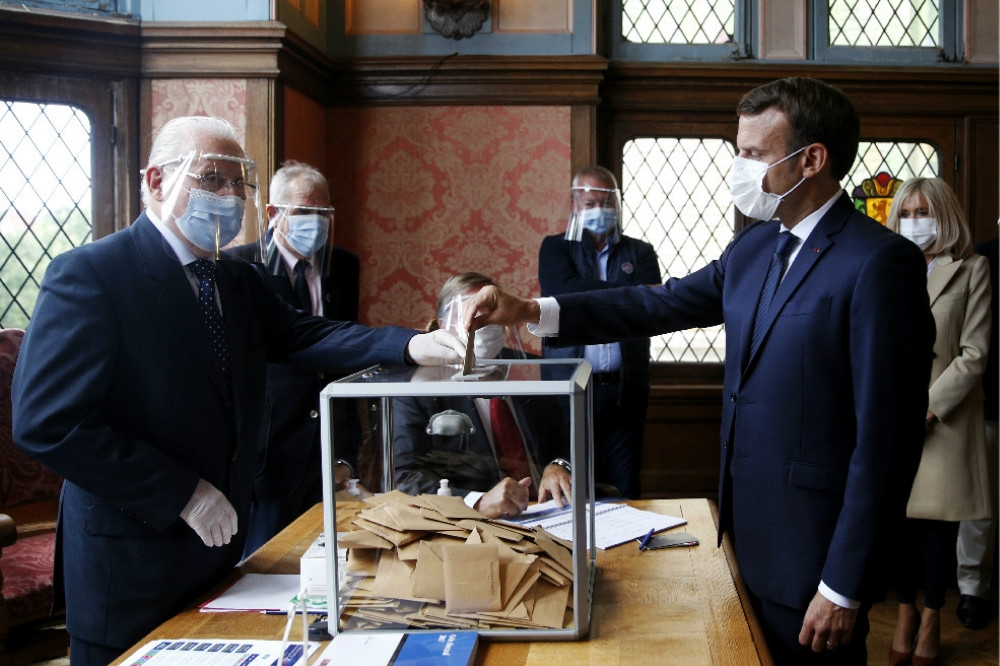 法國總統馬卡洪（右中）與夫人布麗姬（右後）出席投票。（湯森路透）