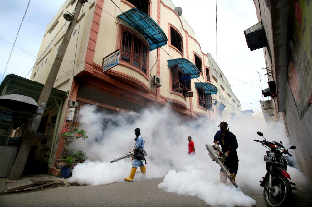 印尼清潔人員對社區進行全面消毒滅蚊。（湯森路透）