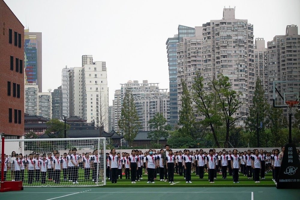 開學第一天，迎接新學期的上海學生。（湯森路透）
