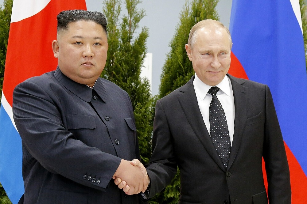 金正恩（左）有意出訪俄國，與總統普丁（右）討論軍援事宜。圖為兩人2019年在海參崴會晤。（資料照片／美聯社）